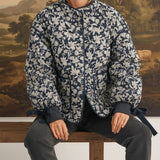 graced Alexis floral quilted cotton jacket with sleeve bows worn by a model sitting on a wooden bench