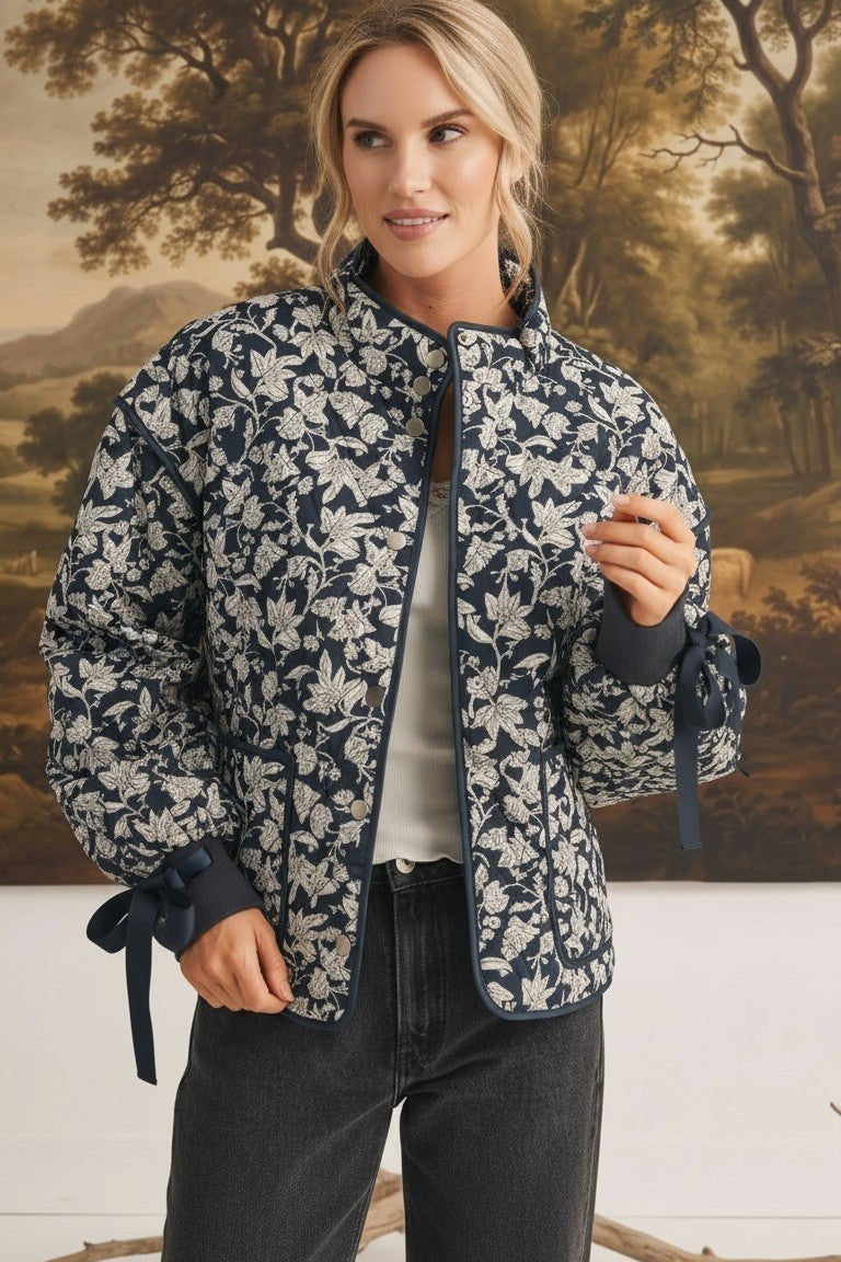graced Alexis floral quilted cotton jacket with navy blue bow sleeve details worn by a model