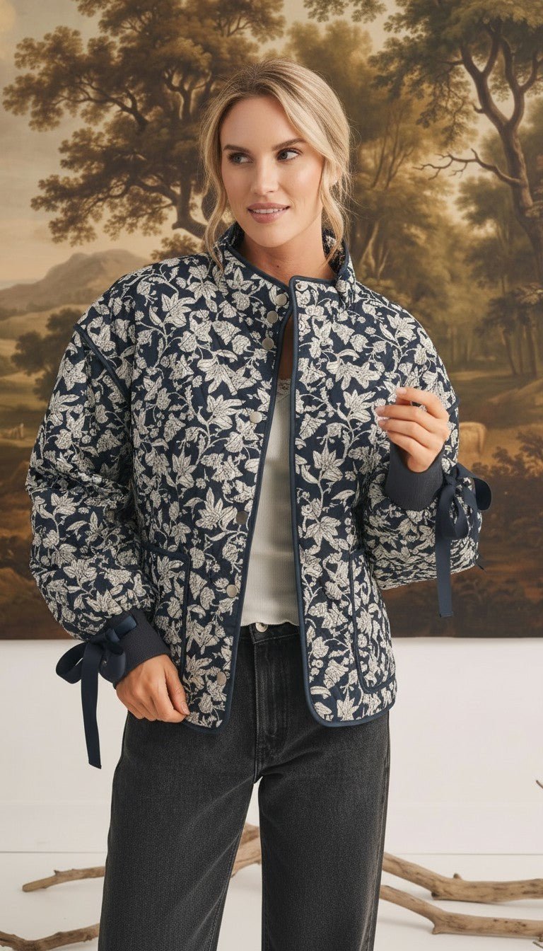 graced Alexis floral quilted cotton jacket with navy blue bow sleeve details worn by a model