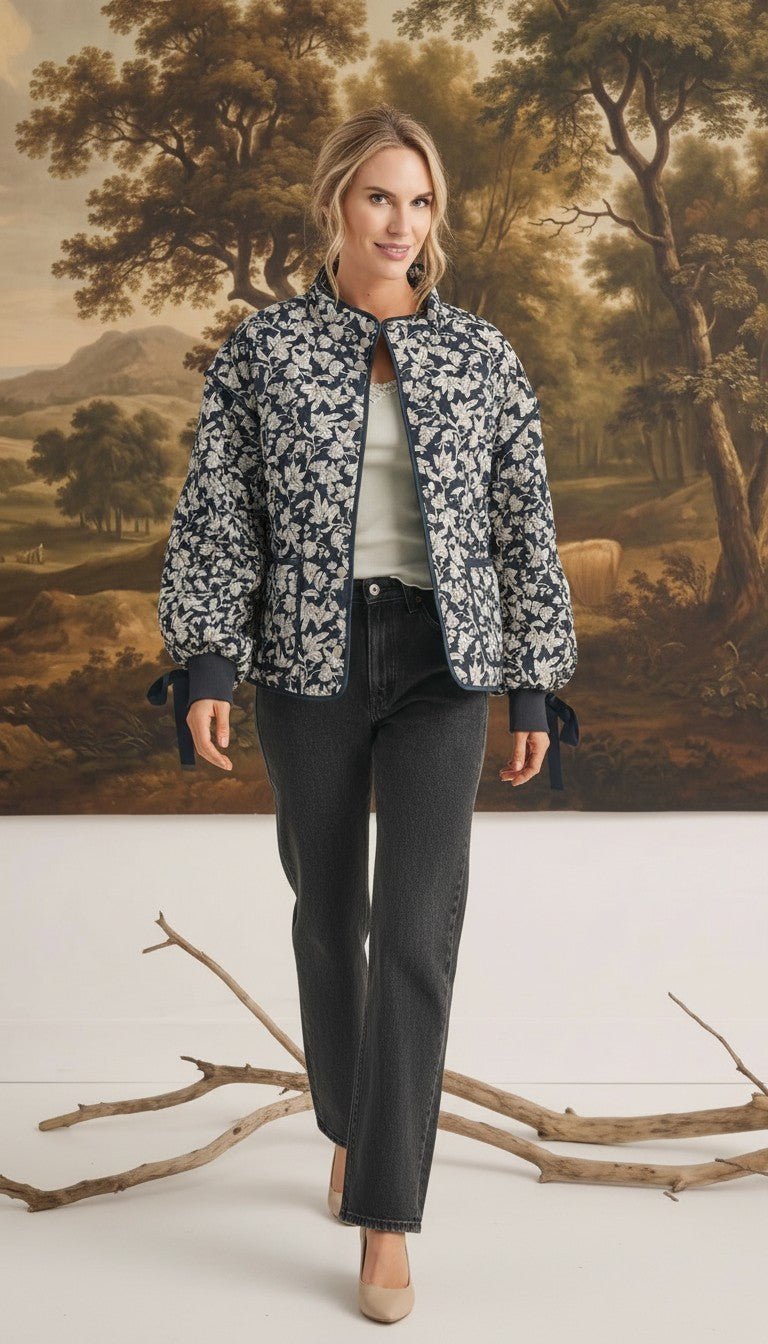 graced Alexis floral quilted cotton jacket with sleeve bows worn by a model in front of a landscape painting