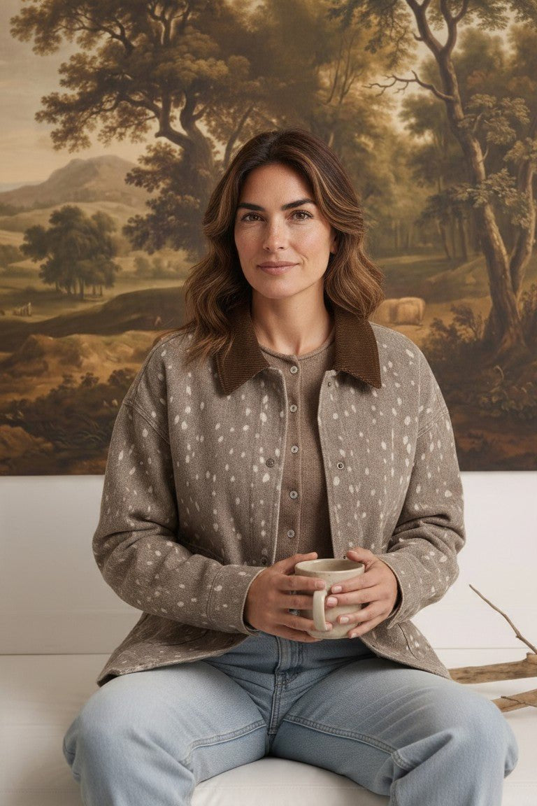 graced Alyssa animal print jacket with a brown corduroy collar worn by a woman holding a mug in a rustic setting