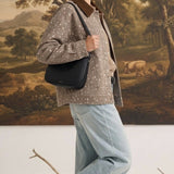 graced Alyssa animal print cotton jacket with a brown corduroy collar worn by a woman with a black shoulder bag
