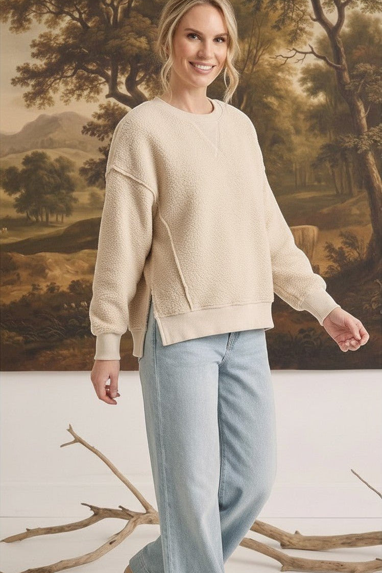Model wearing graced The Ashley cream oversized brushed fleece top with side slits and ribbed cuffs