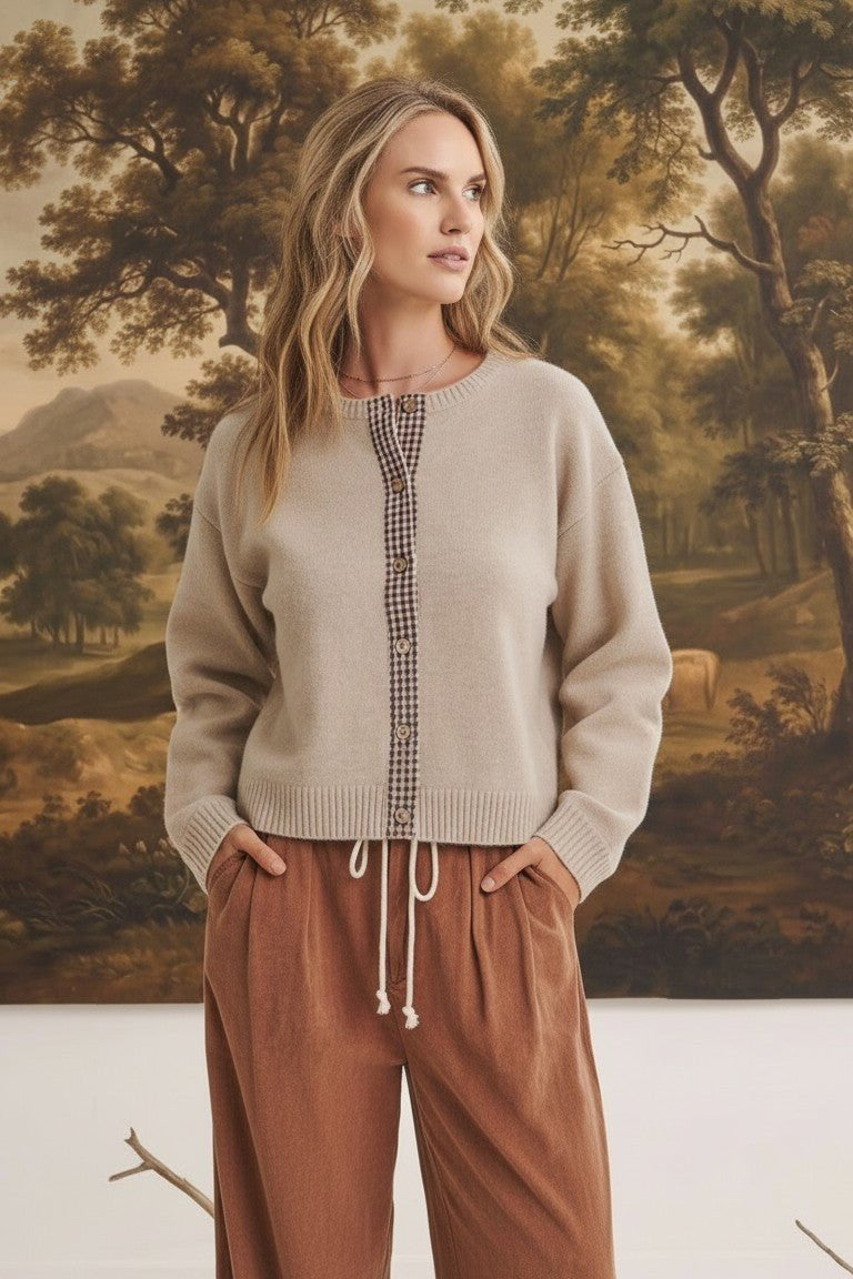 graced Baylie cardigan in beige with brown gingham trim along the button placket worn by a model