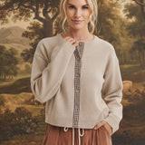 graced Baylie cardigan in beige with brown gingham button placket worn by a model with brown corduroy trousers