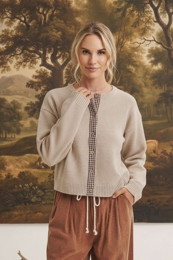 graced Baylie cardigan in beige with brown gingham button placket worn by a model with brown corduroy trousers
