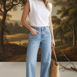 Model wearing graced Blaine high rise straight leg jeans in light blue denim with a white sleeveless top