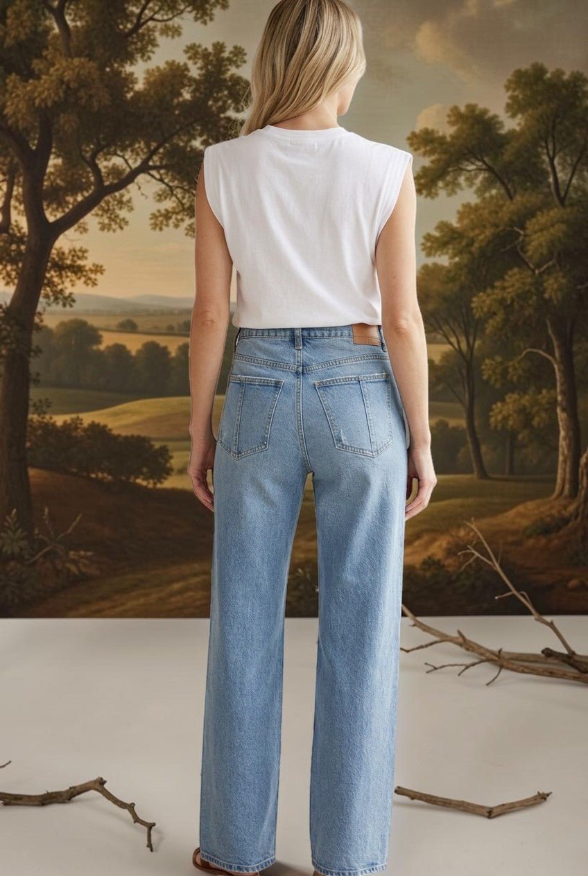 graced Blaine high rise straight leg jeans in light blue denim worn by a woman from the back view