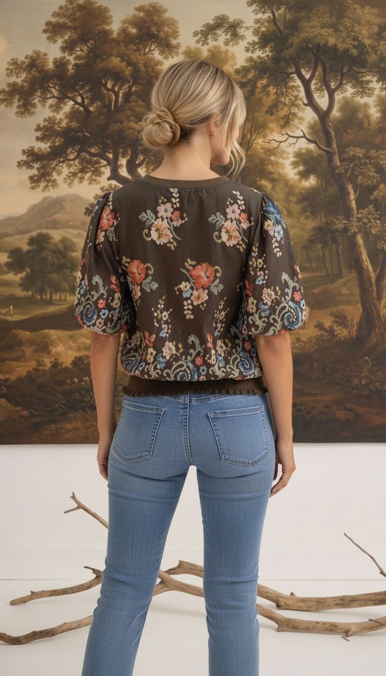 graced Brenda floral top in brown with puff sleeves and ribbed waist, worn by a woman from the back view