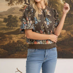 graced Brenda floral top in brown with puff sleeves and ribbed waist, worn by a blonde model with blue jeans