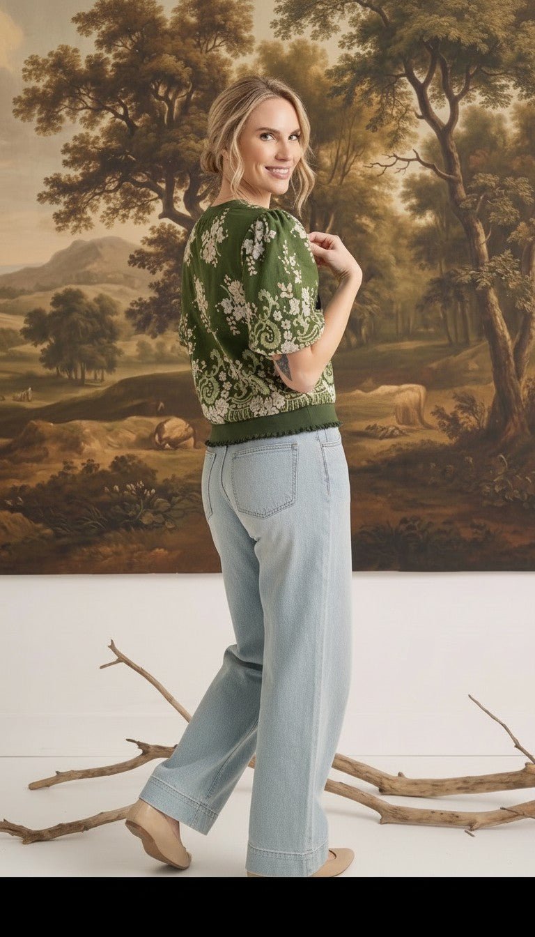 graced Brenda floral top in olive with puff sleeves and ribbed waist, worn by a model with light wash jeans