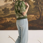 graced Brenda floral top in olive with puff sleeves and ribbed waist, worn by a model with light wash jeans