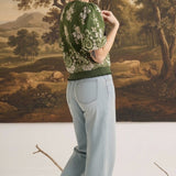 graced Brenda floral top in olive with puff sleeves and ribbed waist, worn by a model with light wash jeans