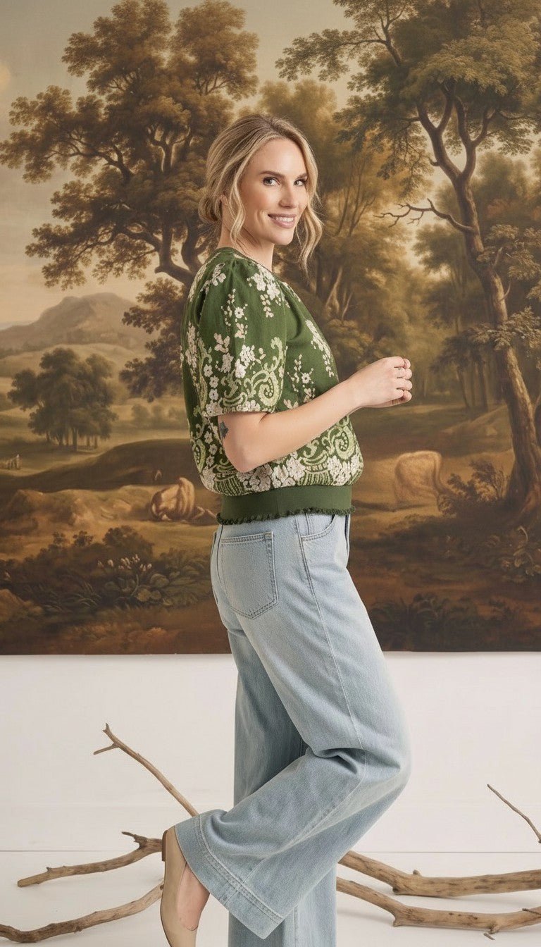 graced Brenda floral top in olive green with puff sleeves and ribbed waist, worn by a woman with light blue jeans