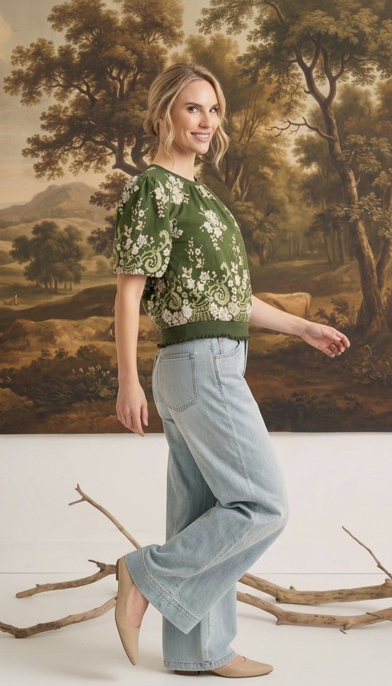 graced Brenda floral top in olive with puff sleeves and ribbed waist, worn by a model with light wash jeans