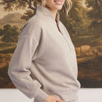 graced Brooklyn Rib Quarter Zip sweater in heather taupe worn by a blonde model against a landscape backdrop
