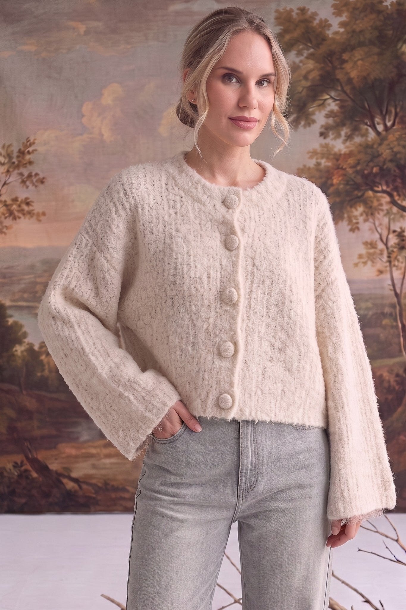 graced The Callie fuzzy knit cardigan in cream with a round neckline and button front, worn by a model.