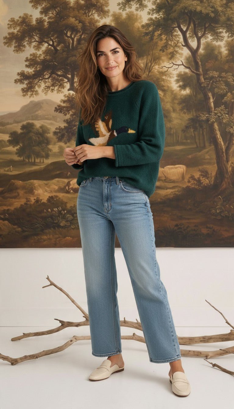 graced Carley Mallard sweater in forest green featuring a mallard duck design, worn with light wash jeans