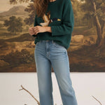 graced Carley Mallard sweater in forest green featuring a mallard duck design, worn with light wash jeans