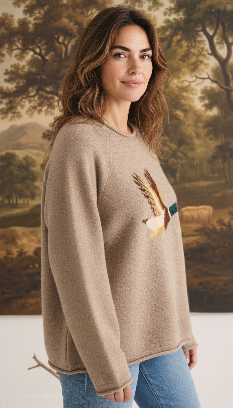 graced Carley Mallard sweater in mocha featuring a mallard duck graphic, worn by a woman with blue jeans