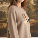 graced Carley Mallard sweater in mocha featuring a mallard duck graphic, worn by a woman with blue jeans