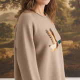 graced Carley Mallard sweater in mocha featuring a mallard duck graphic, worn by a woman with blue jeans