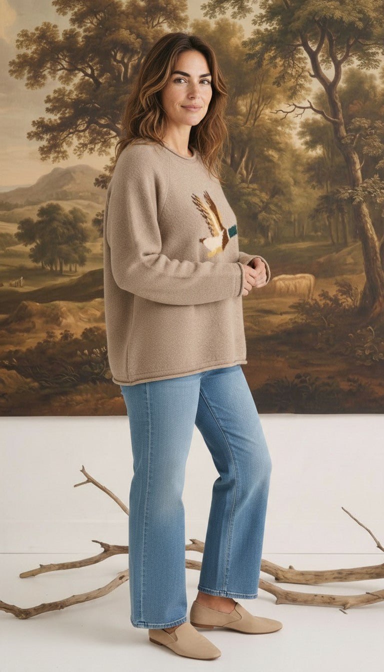 graced Carley Mallard sweater in mocha featuring a mallard duck graphic, worn by a model with blue jeans