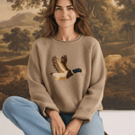 graced Carley Mallard sweater in mocha featuring a mallard duck knit design, worn by a woman with blue jeans