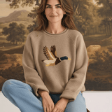 graced Carley Mallard sweater in mocha featuring a mallard duck knit design, worn by a woman with blue jeans