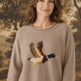 graced Carley Mallard sweater in mocha featuring a flying duck intarsia knit design worn by a woman