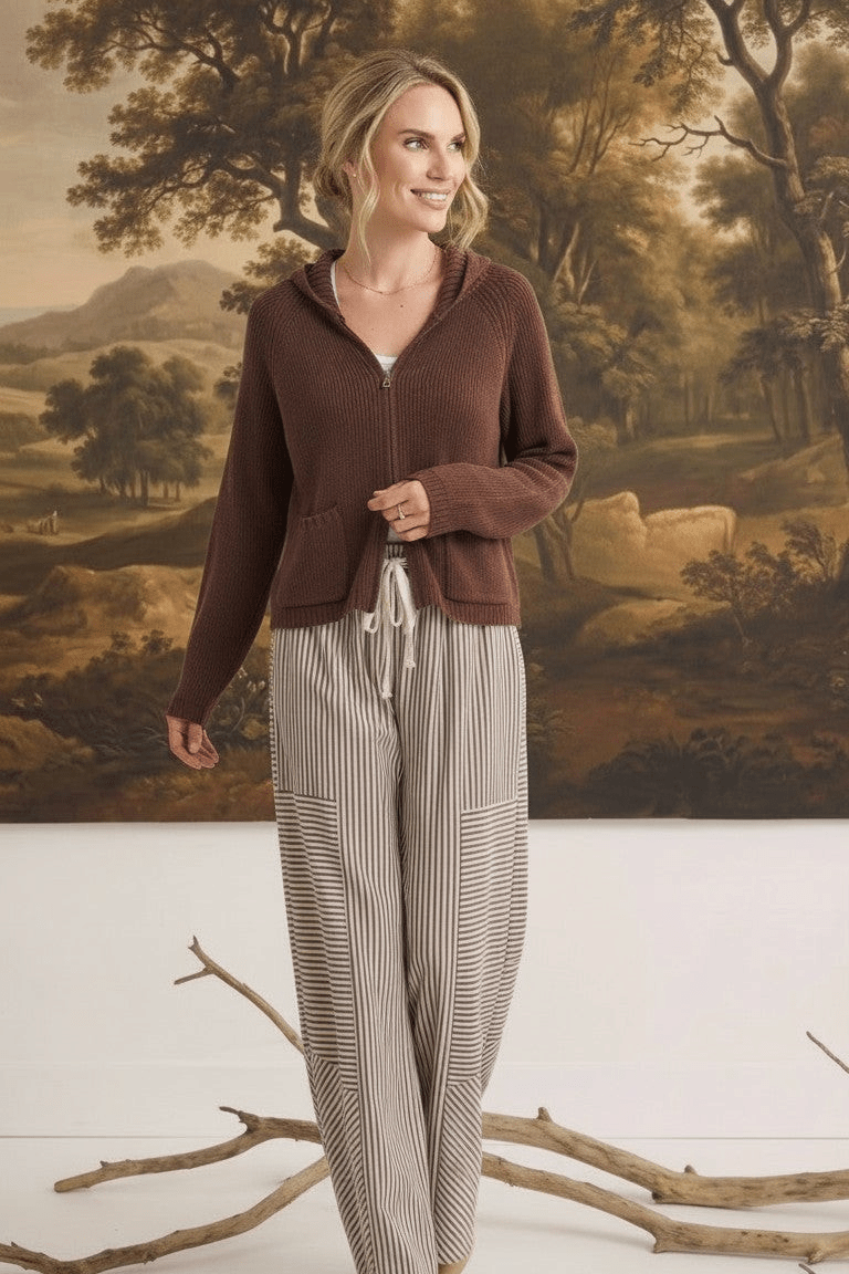 Model wearing graced The Carly Mixed Stripe wide leg pants with a brown zip-up hoodie in a studio setting