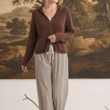 Model wearing graced The Carly Mixed Stripe wide leg pants with a brown zip-up hoodie in a studio setting