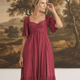 graced Celeste midi dress in deep red with puff sleeves and a sweetheart neckline worn by a model
