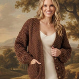 graced Chloe chunky knit cardigan in mocha brown with front pockets and buttons worn over a cream slip dress