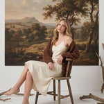 graced Chloe chunky knit cardigan in mocha worn by a blonde model over a cream slip dress in a rustic setting