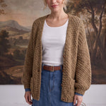graced Chloe chunky knit olive cardigan worn by a model over a white top and denim skirt