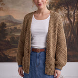 graced Chloe chunky knit olive cardigan worn by a model over a white top and denim skirt
