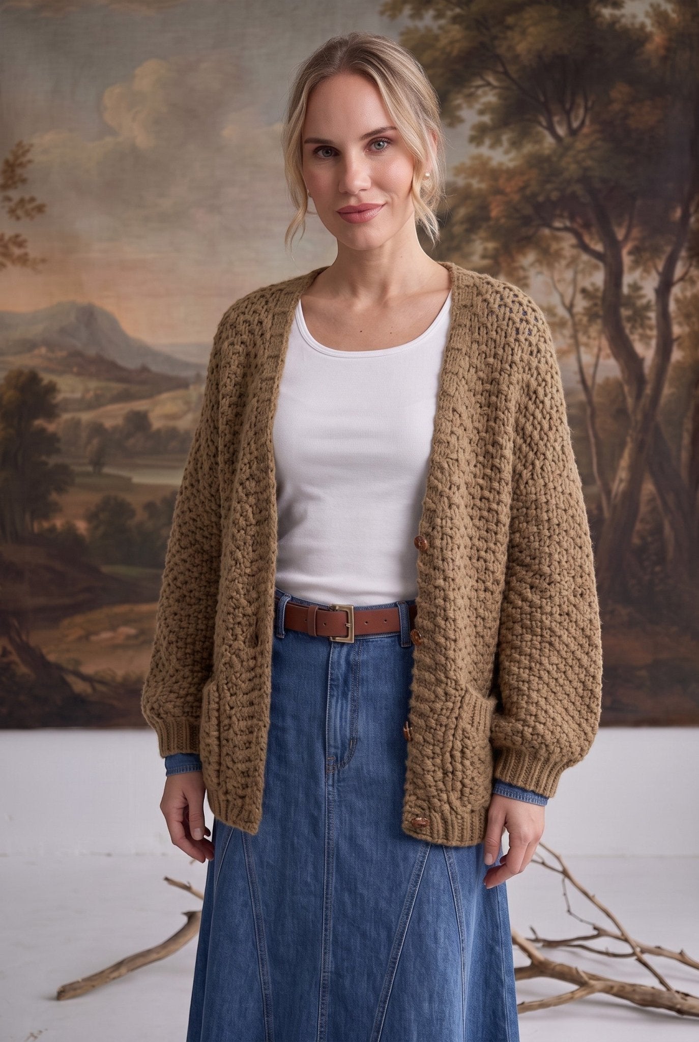 graced Chloe chunky knit olive cardigan worn by a model over a white top and denim skirt