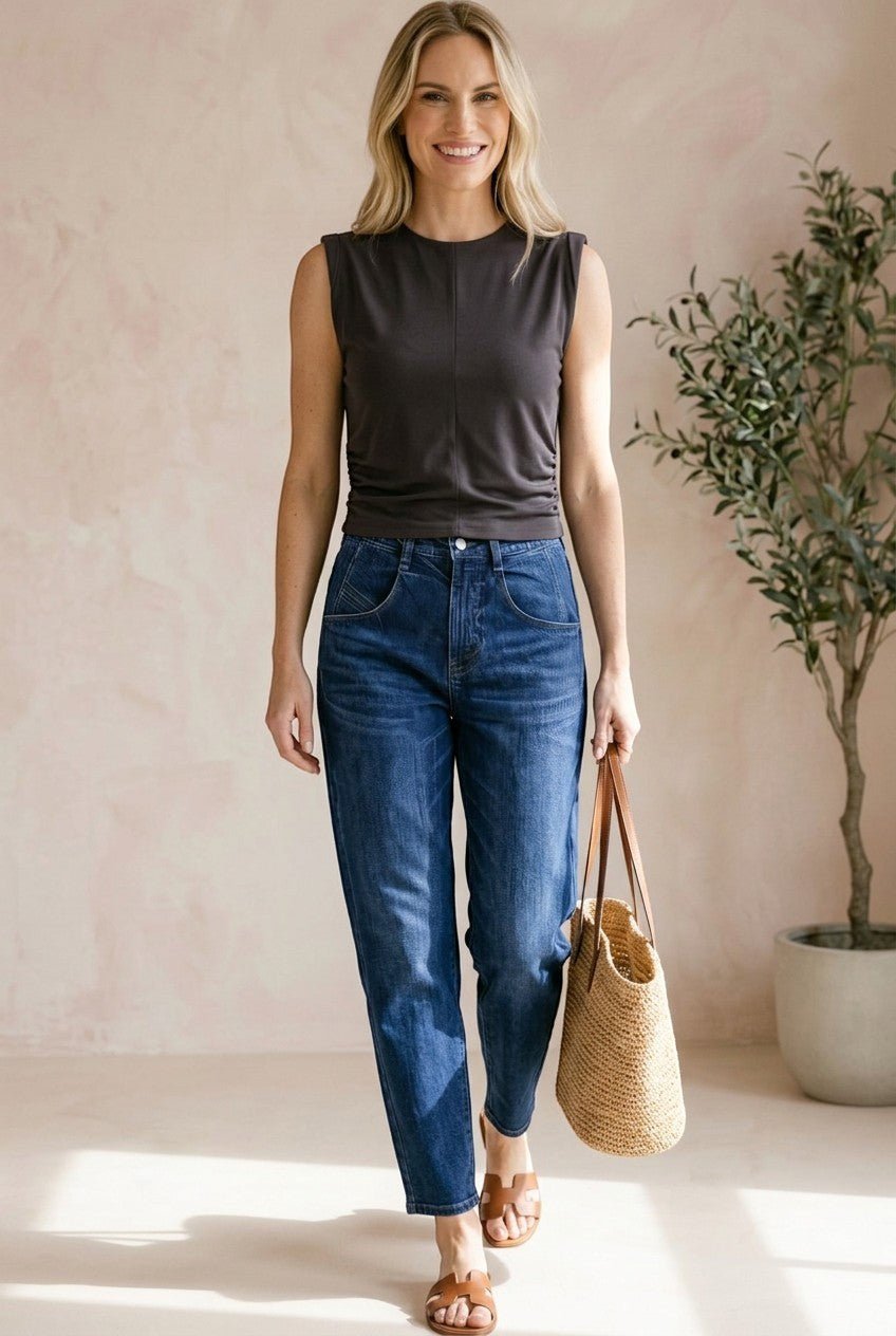 graced chocolate brown sleeveless cotton top with side tie detail worn by a woman with blue jeans and a straw bag