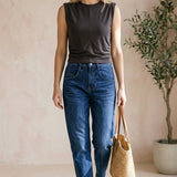 graced chocolate brown sleeveless cotton top with side tie detail worn by a woman with blue jeans and a straw bag