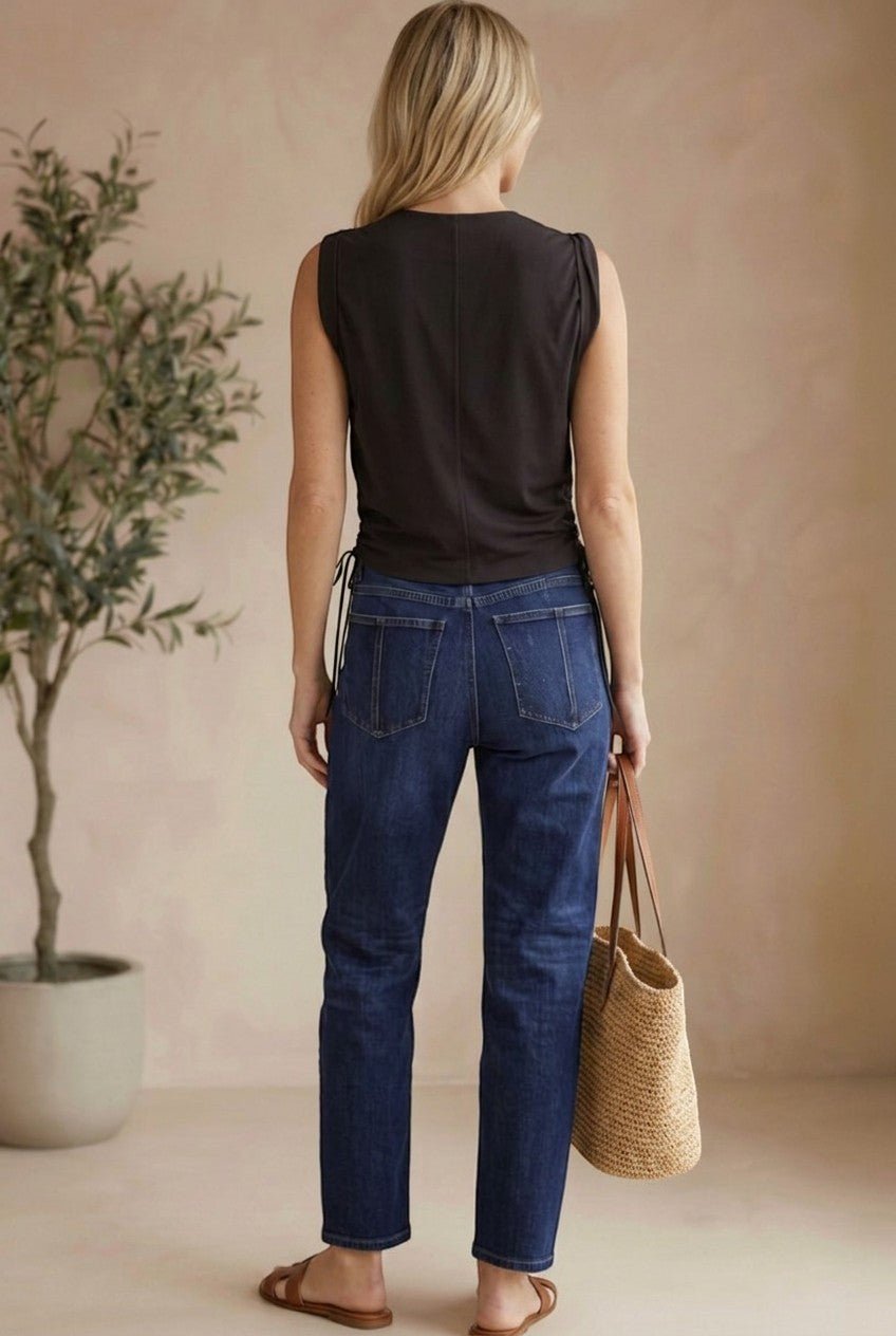 graced chocolate brown cotton sleeveless top with side tie detail worn by a model with blue jeans and a straw bag