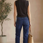 graced chocolate brown cotton sleeveless top with side tie detail worn by a model with blue jeans and a straw bag