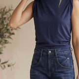 graced The Cinch Side Top in new navy cotton with a flattering side tie detail worn by a smiling blonde model