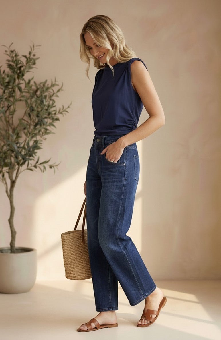 graced navy cotton Cinch Side Top with side tie detail worn by a blonde model with blue jeans and brown sandals