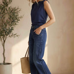 graced navy cotton Cinch Side Top with side tie detail worn by a blonde model with blue jeans and brown sandals