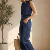 graced navy cotton Cinch Side Top with side tie detail worn by a blonde model with blue jeans and brown sandals