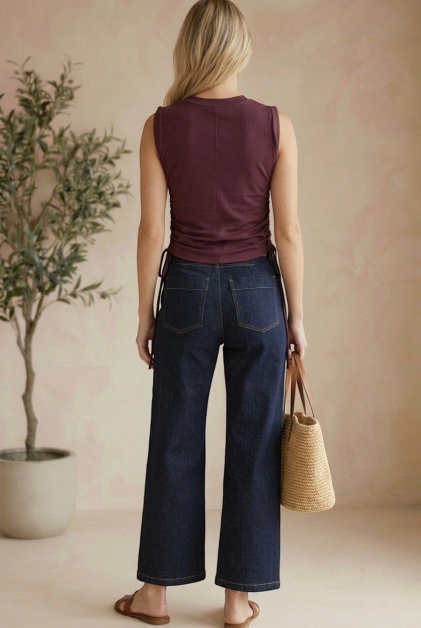 graced Cinch Side Top in winetasting cotton with side tie detail, worn by a woman with dark denim jeans