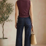 graced Cinch Side Top in winetasting cotton with side tie detail, worn by a woman with dark denim jeans