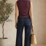 graced Cinch Side Top in winetasting cotton with side tie detail, worn by a woman with dark denim jeans