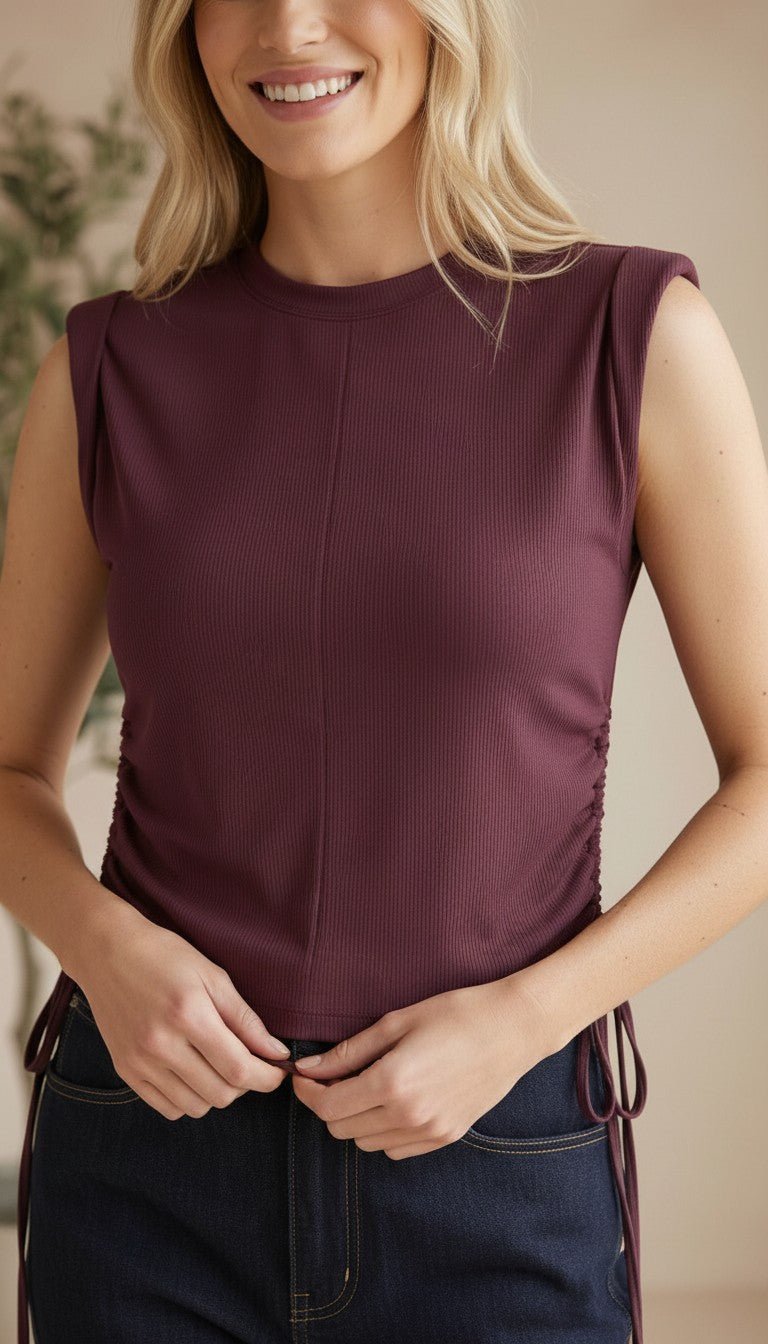 graced Cinch Side Top in winetasting ribbed cotton with side tie detail and sleeveless silhouette on a smiling model